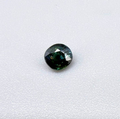 0.32 ct natural teal Laos sapphire with oval-cushion faceted cut and vibrant blue green colour