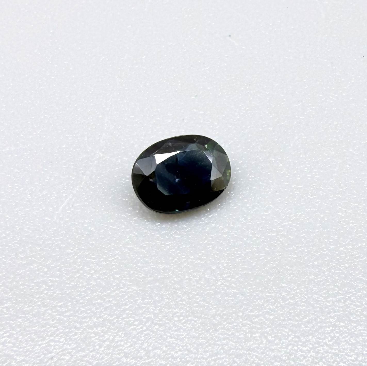 0.43 ct natural teal Laos sapphire with oval faceted cut and rich teal colour