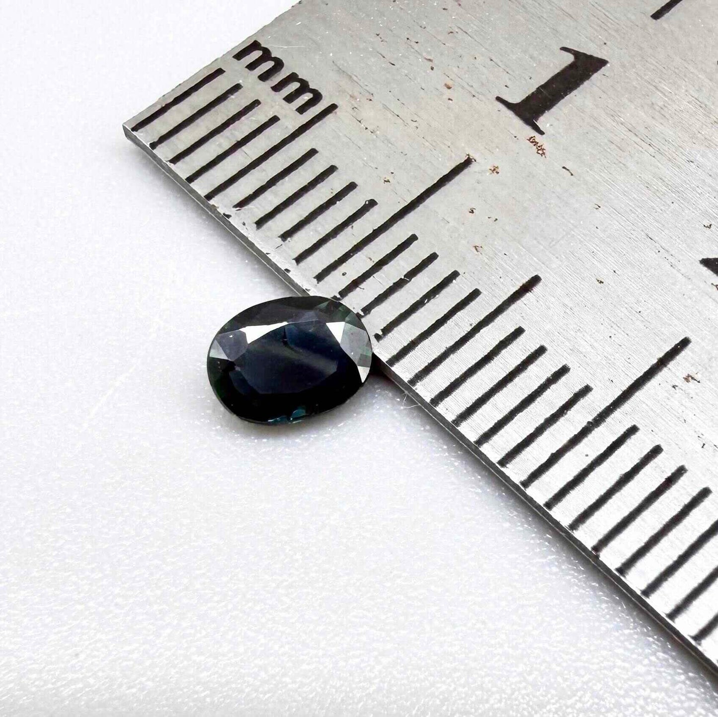 0.43 ct natural teal Laos sapphire with oval faceted cut and rich teal colour