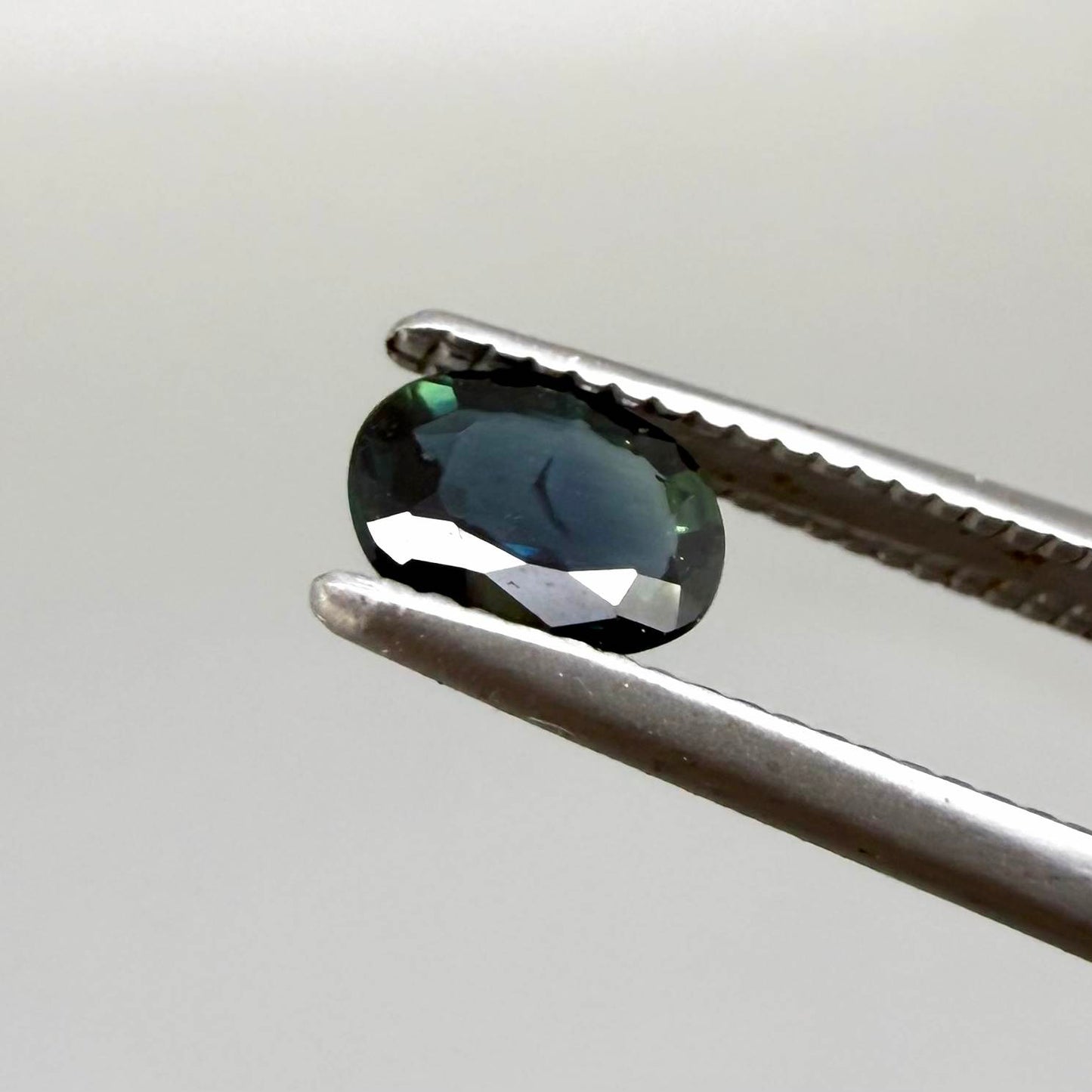 0.43 ct natural teal Laos sapphire with oval faceted cut and rich teal colour