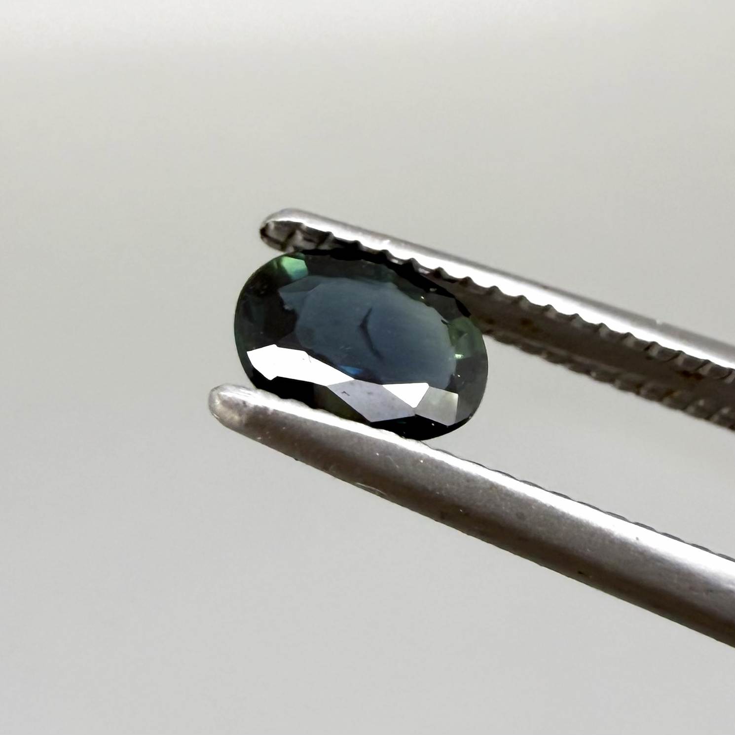 0.43 ct natural teal Laos sapphire with oval faceted cut and rich teal colour
