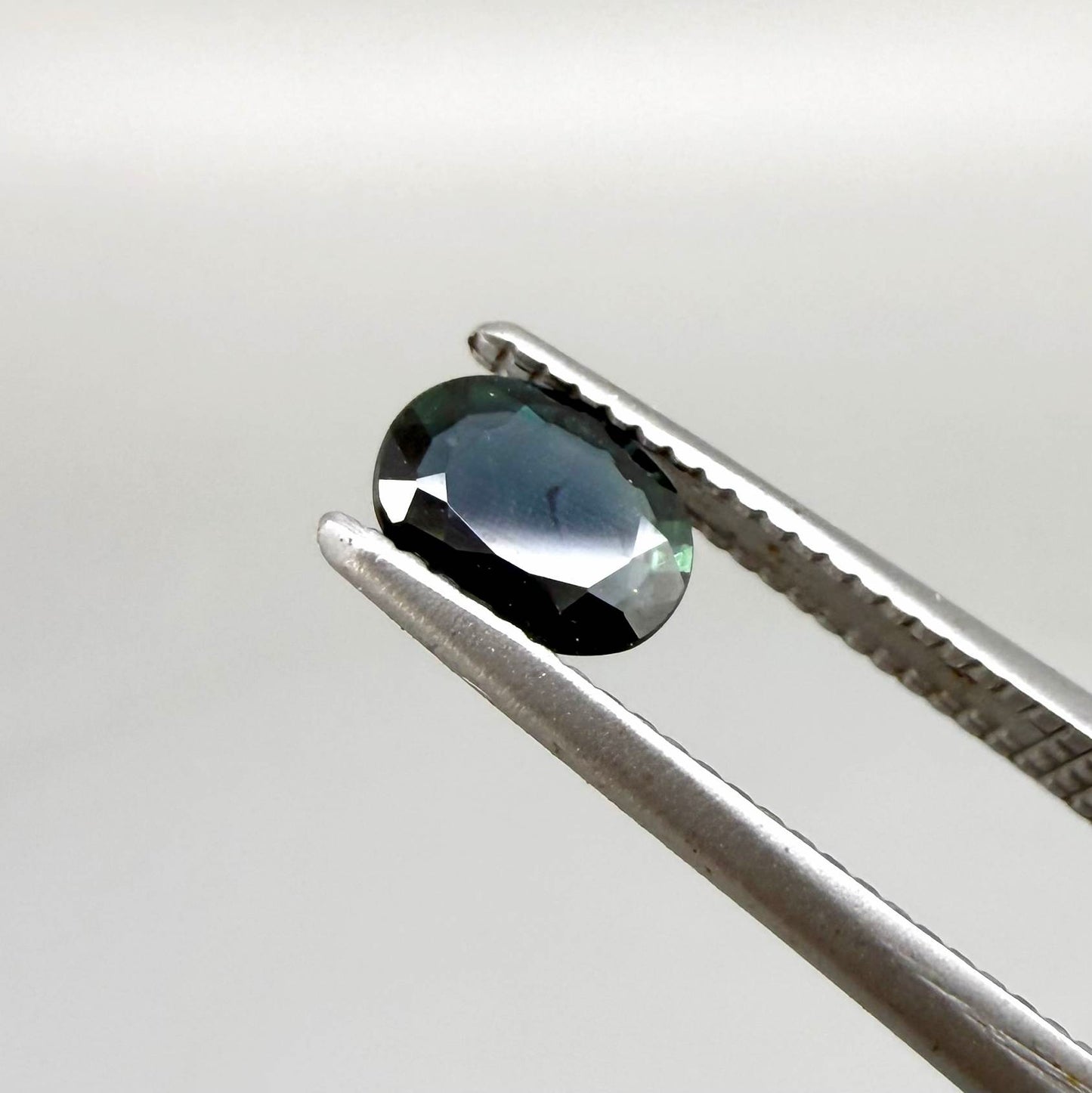 0.43 ct natural teal Laos sapphire with oval faceted cut and rich teal colour