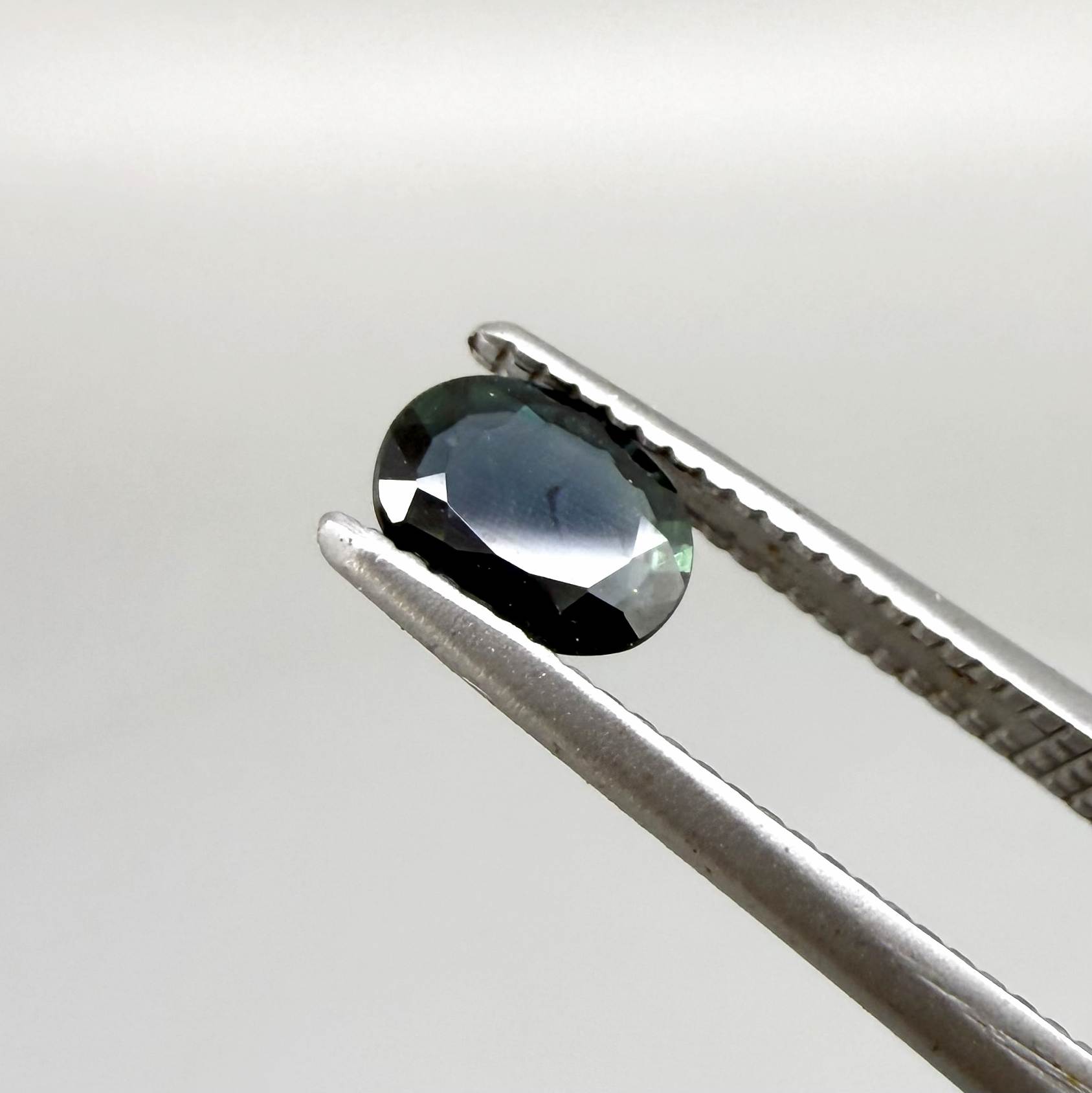 0.43 ct natural teal Laos sapphire with oval faceted cut and rich teal colour