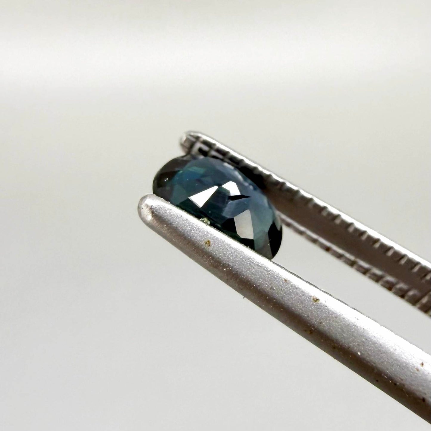 0.43 ct natural teal Laos sapphire with oval faceted cut and rich teal colour