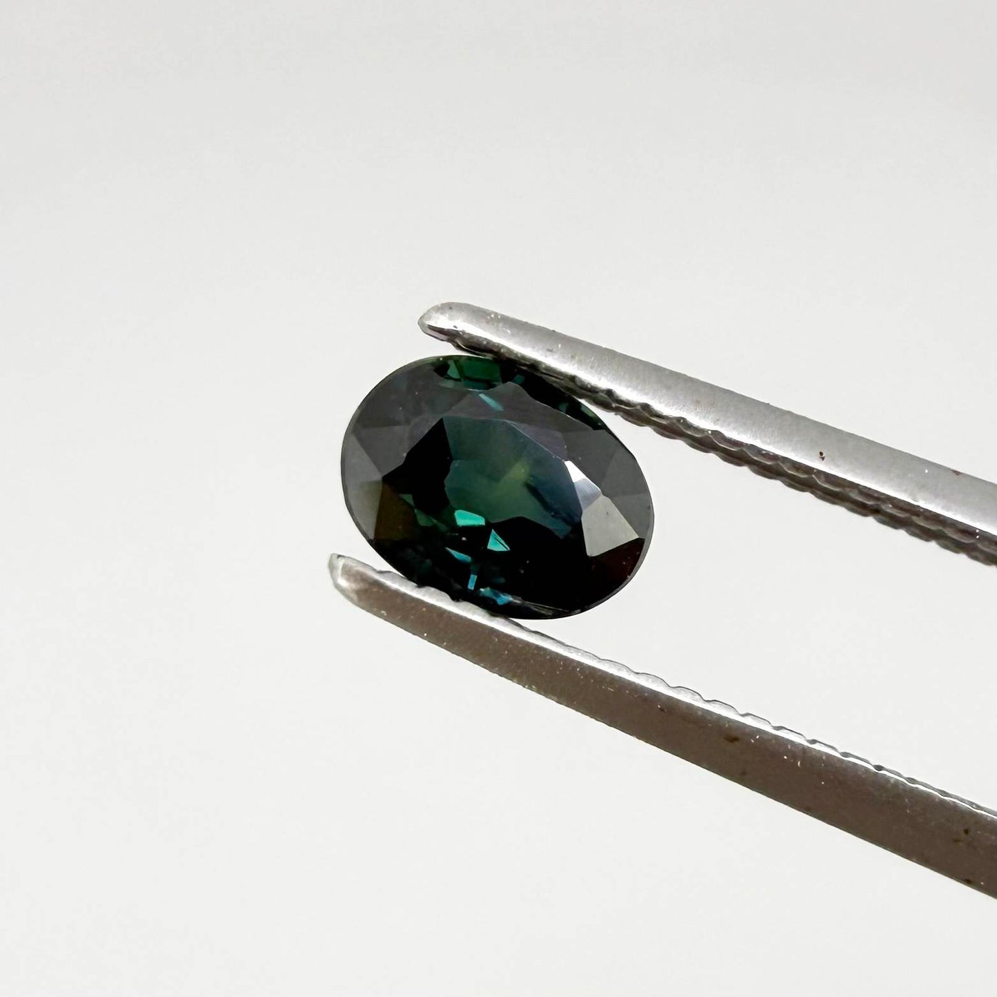 0.51 ct natural teal Laos sapphire with oval faceted cut and rich teal colour