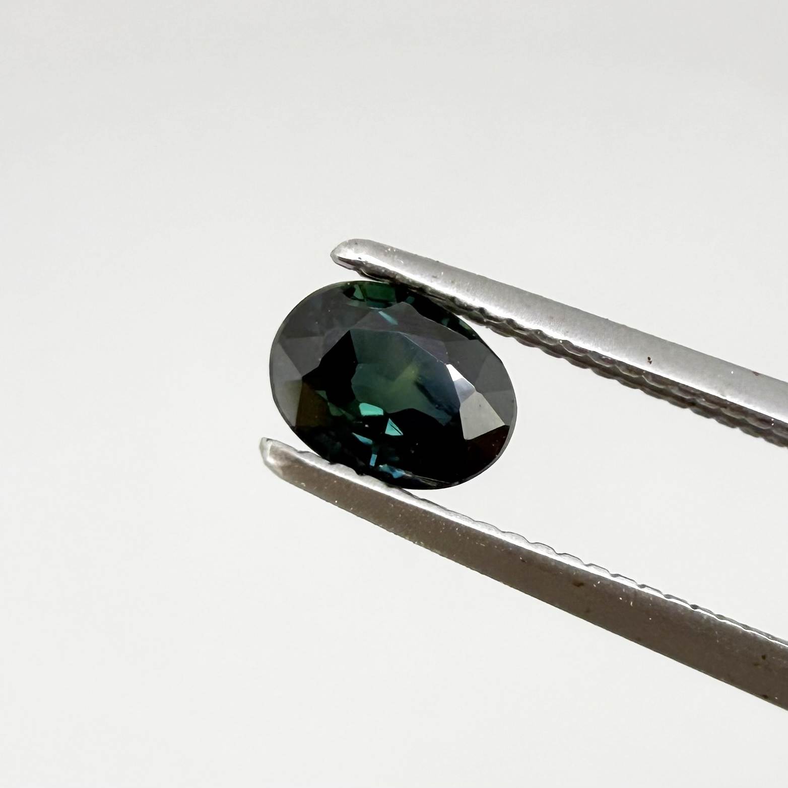 0.51 ct natural teal Laos sapphire with oval faceted cut and rich teal colour