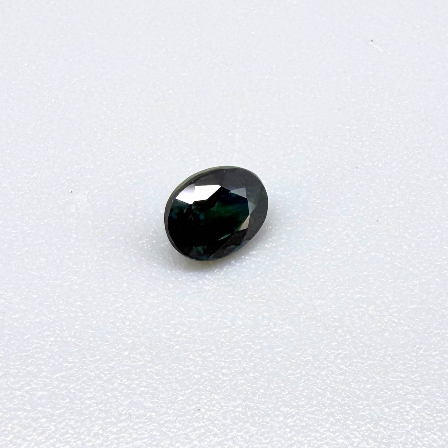 0.51 ct natural teal Laos sapphire with oval faceted cut and rich teal colour