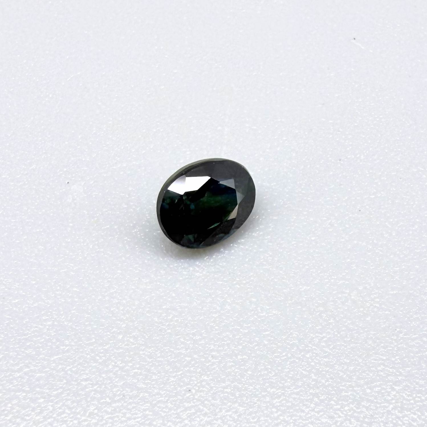 0.51 ct natural teal Laos sapphire with oval faceted cut and rich teal colour