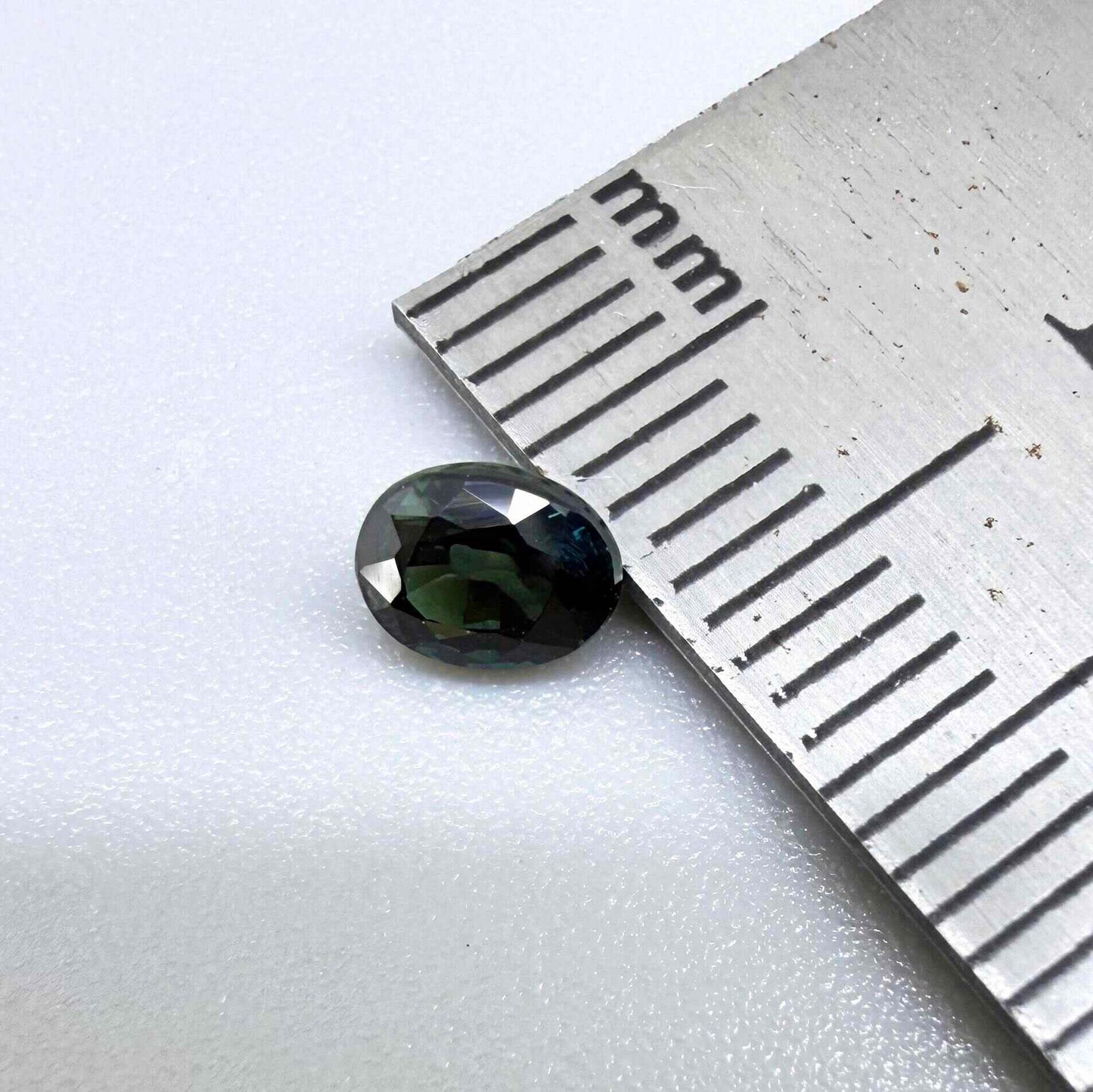 0.51 ct natural teal Laos sapphire with oval faceted cut and rich teal colour