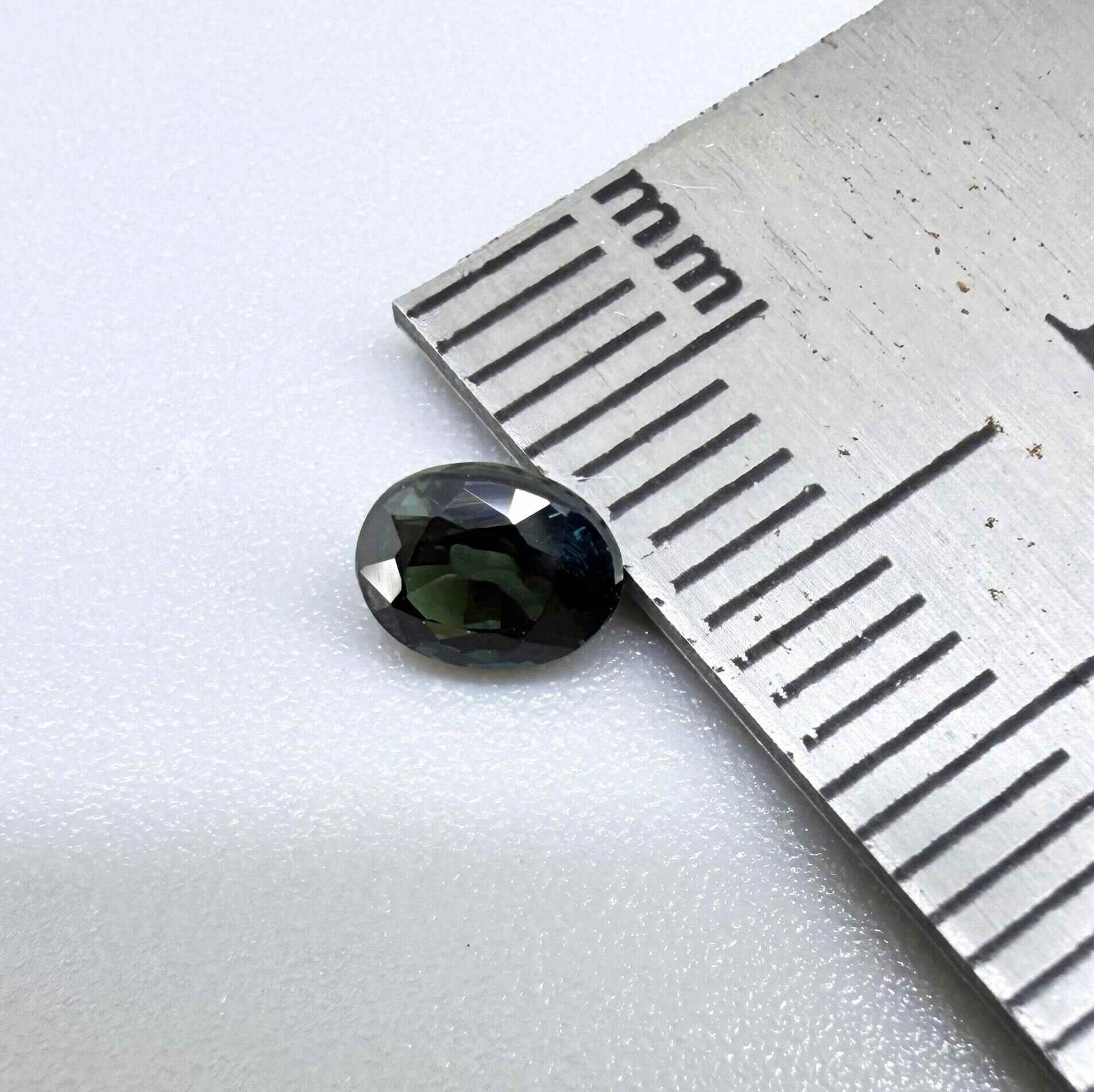 0.51 ct natural teal Laos sapphire with oval faceted cut and rich teal colour