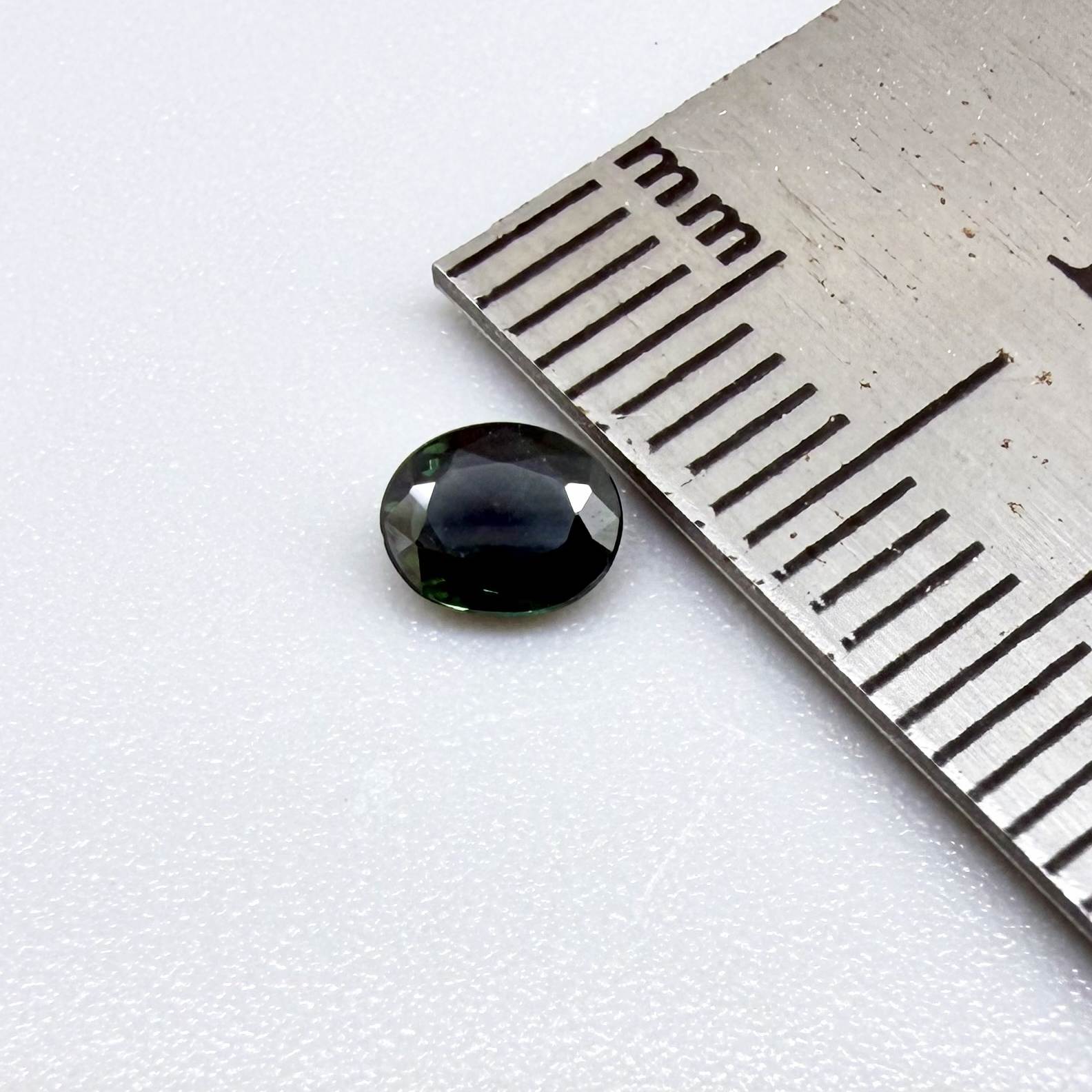 0.30 ct natural green Laos sapphire with oval faceted cut and rich green colour
