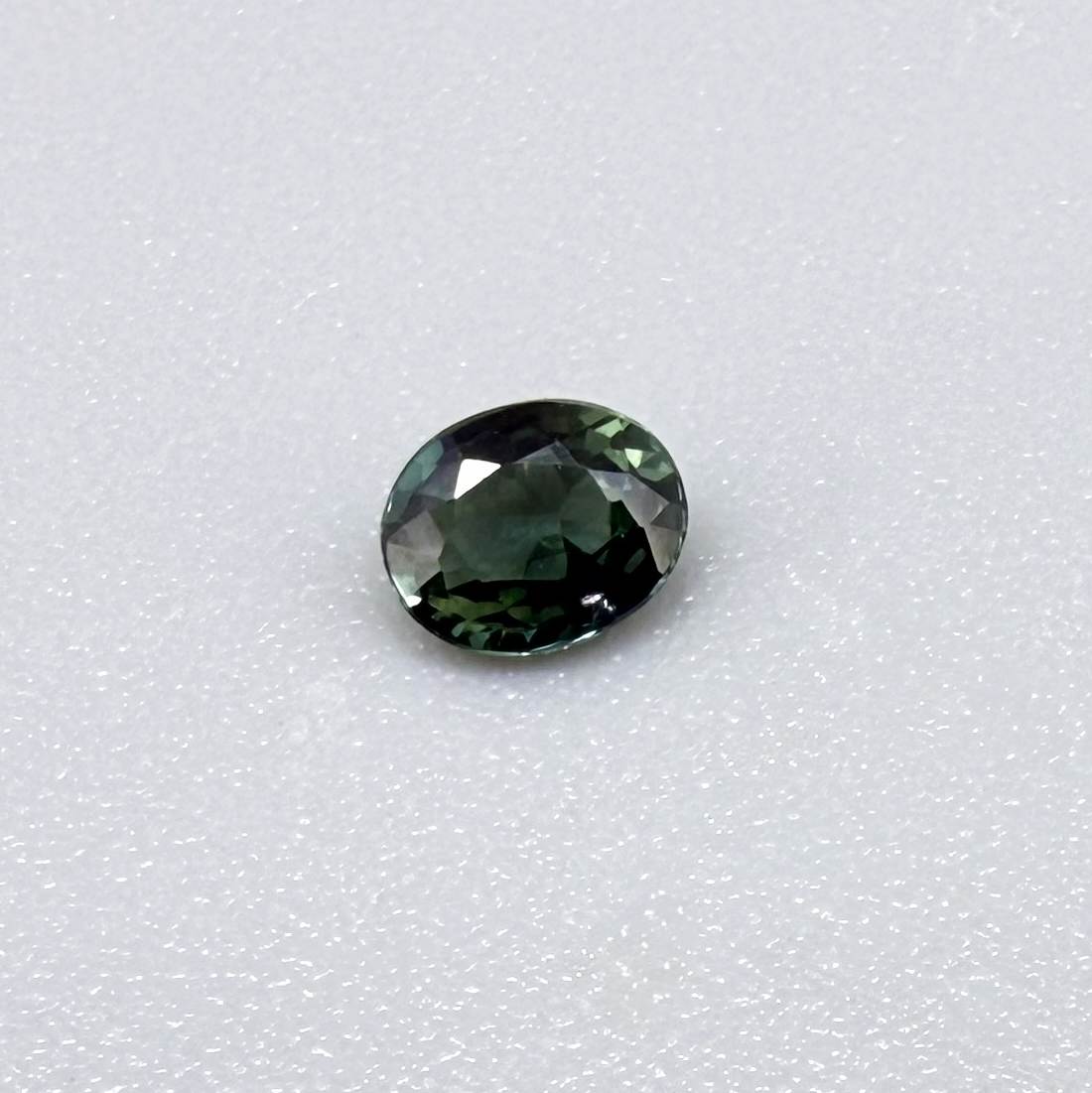 0.30 ct natural teal Laos sapphire with oval faceted cut and vibrant teal colour