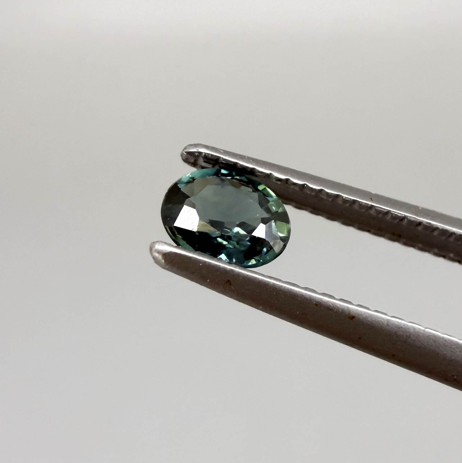 0.30 ct natural teal Laos sapphire with oval faceted cut and vibrant teal colour