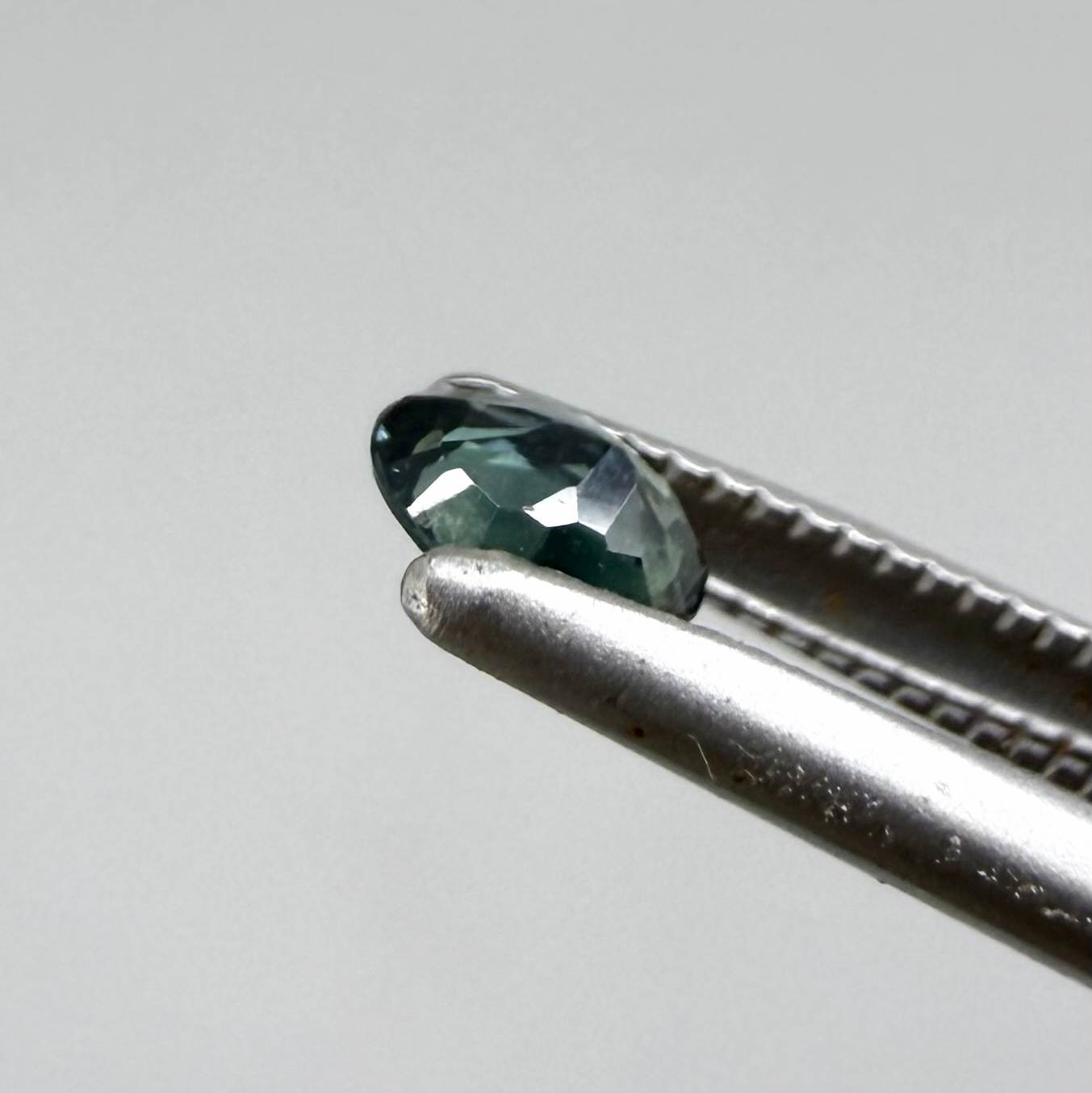 0.30 ct natural teal Laos sapphire with oval faceted cut and vibrant teal colour