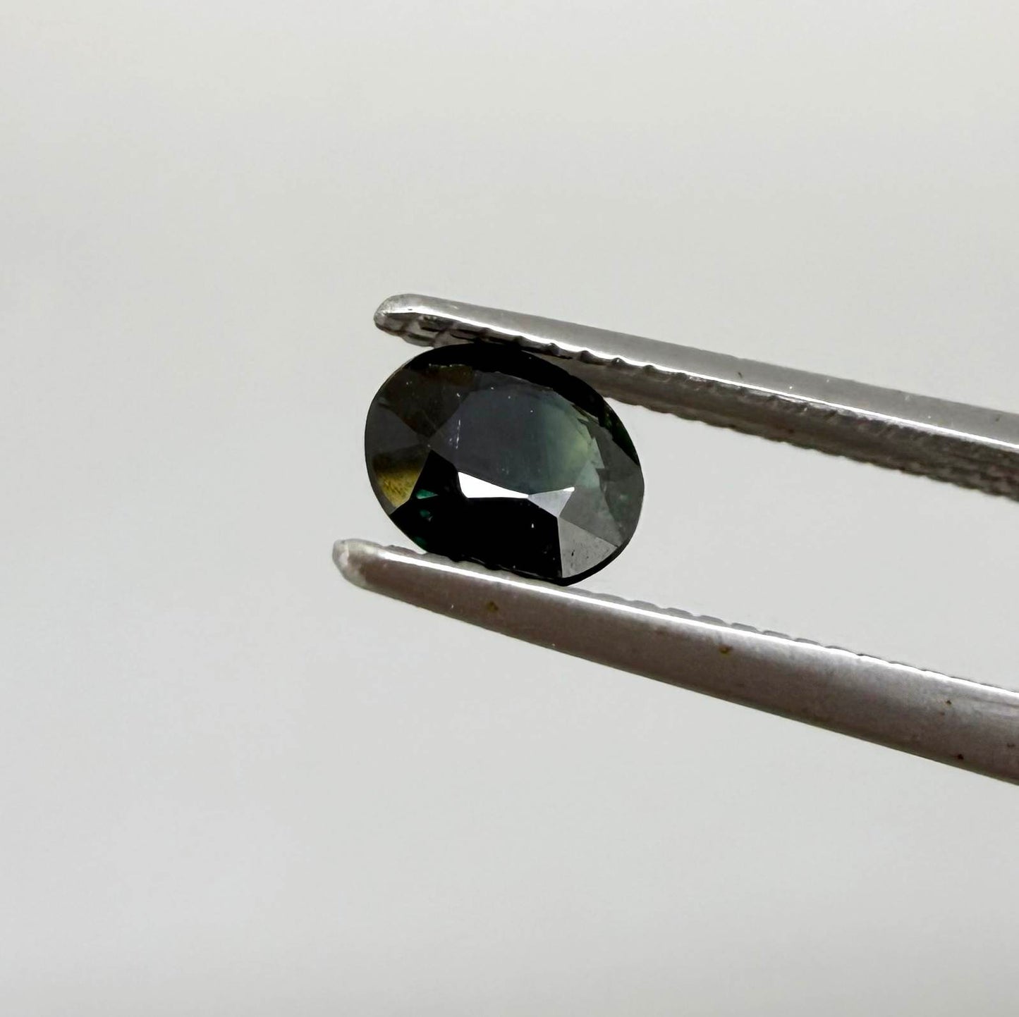 0.34 ct natural deep teal Laos sapphire with oval faceted cut and rich teal colour