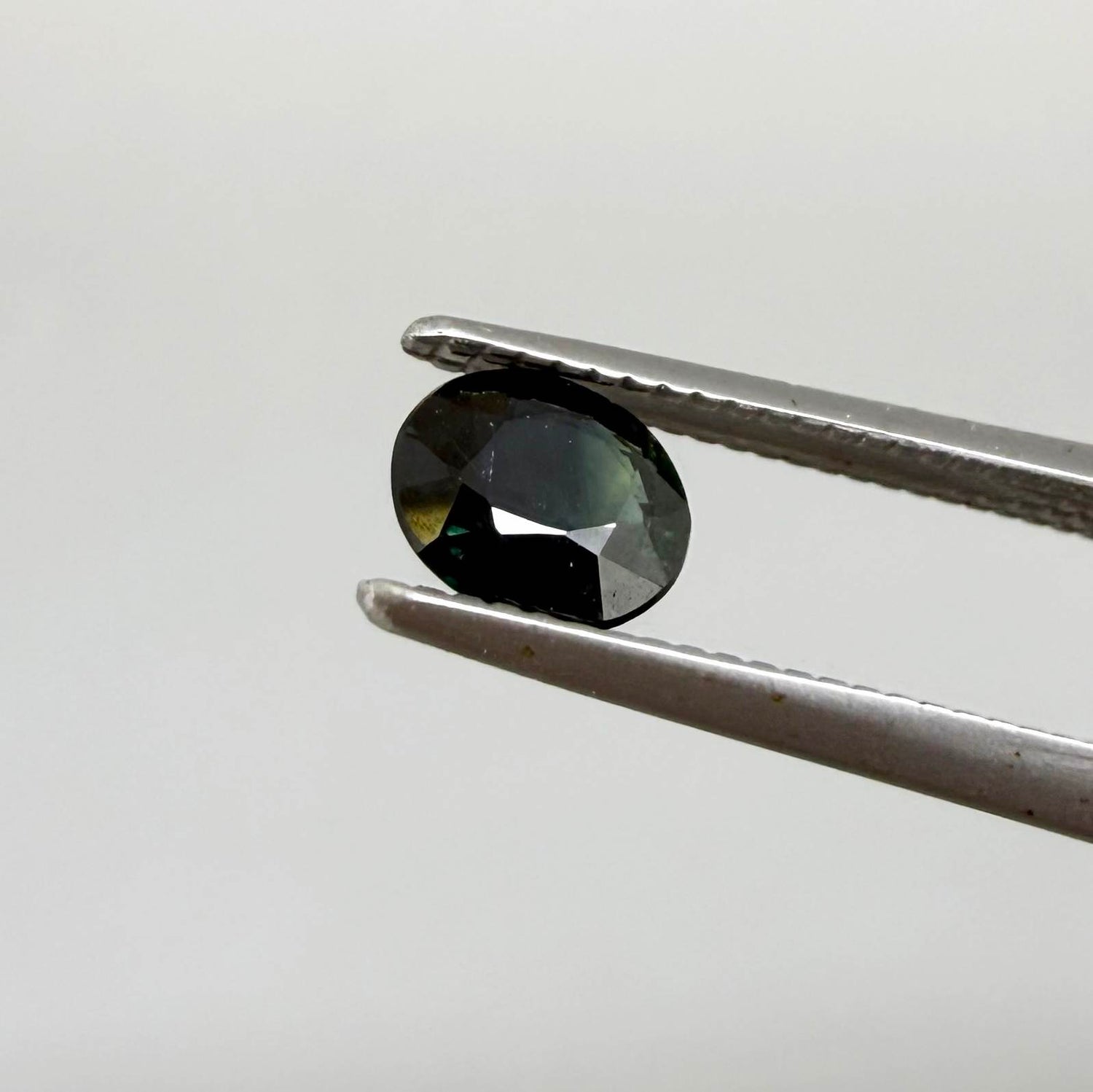 0.34 ct natural deep teal Laos sapphire with oval faceted cut and rich teal colour