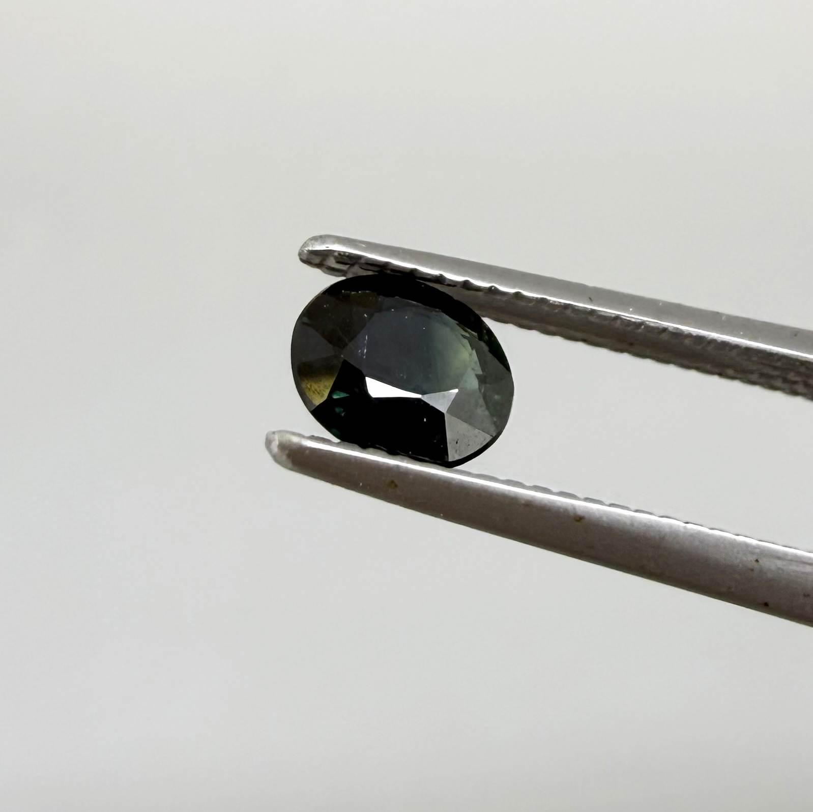 0.34 ct natural deep teal Laos sapphire with oval faceted cut and rich teal colour