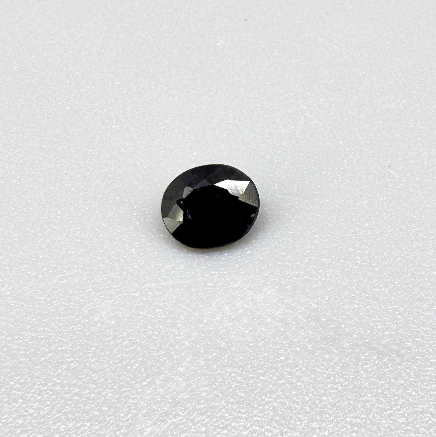 0.34 ct natural deep teal Laos sapphire with oval faceted cut and rich teal colour
