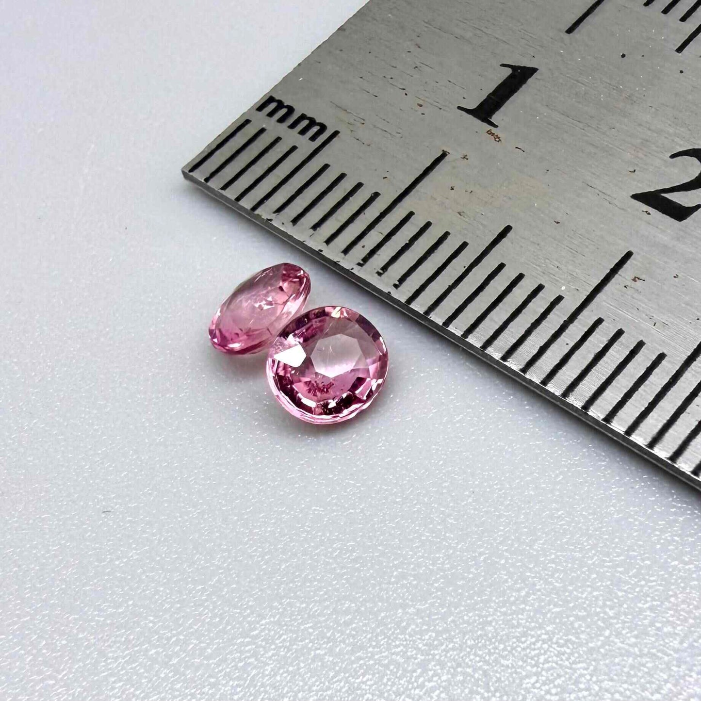 Natural untreated pink tourmaline matching pair, 0.84 ct total weight, round cut gemstones from Nigeria with soft pink colour for custom earrings.