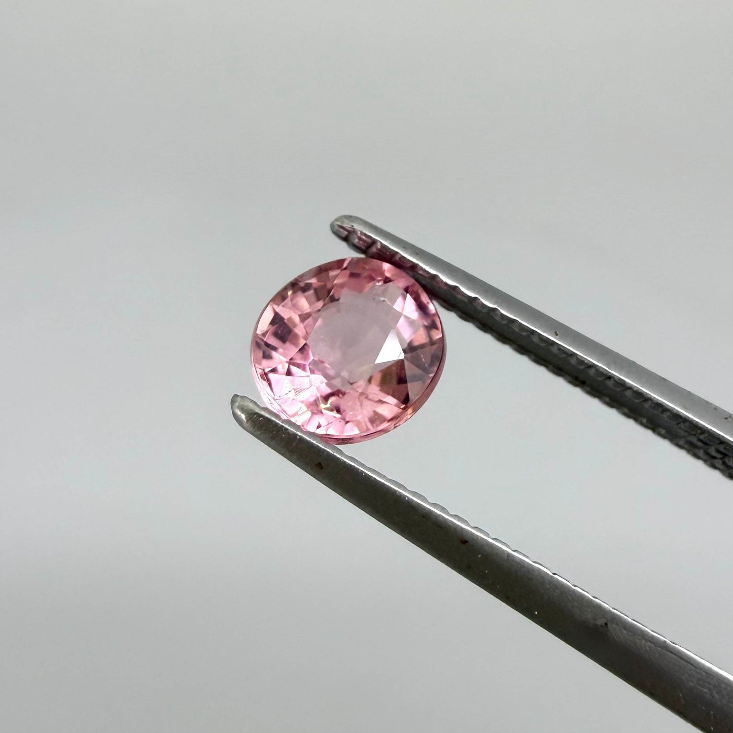 Natural untreated pink tourmaline, 0.57 ct round cut from Nigeria, eye-clean with bright pink colour and excellent brilliance.
