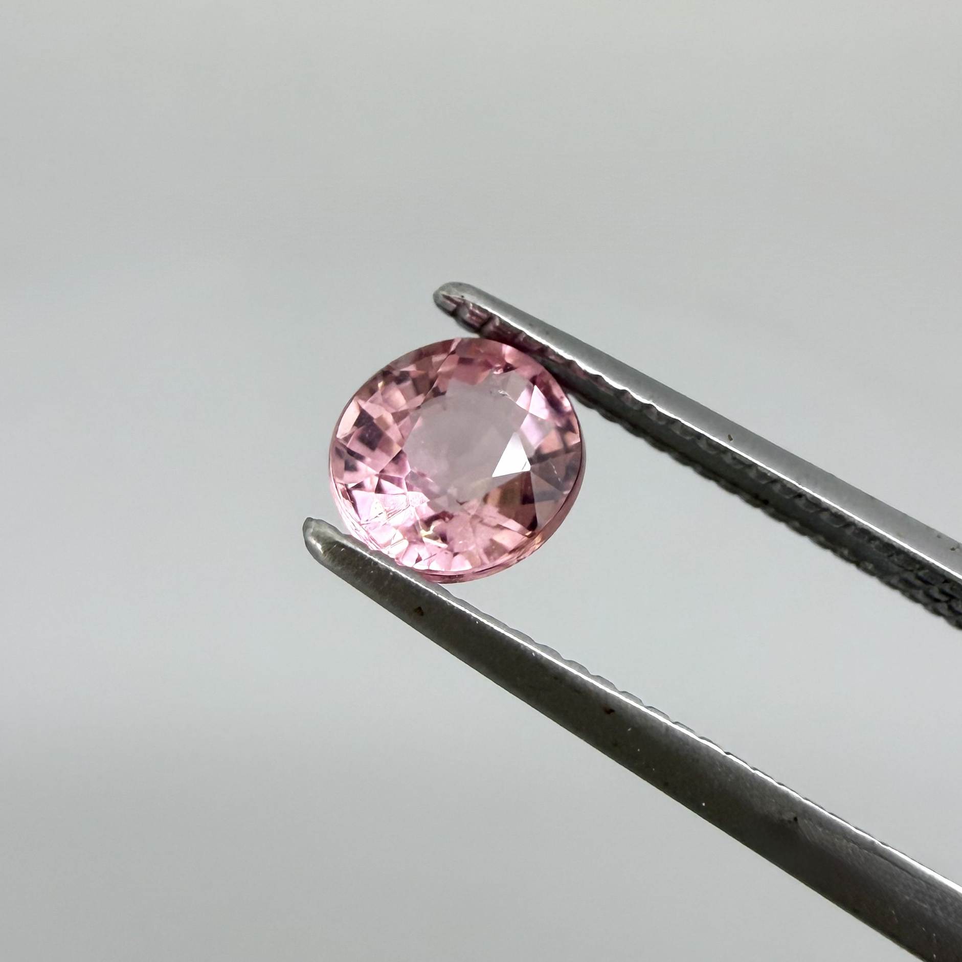 Natural untreated pink tourmaline, 0.57 ct round cut from Nigeria, eye-clean with bright pink colour and excellent brilliance.