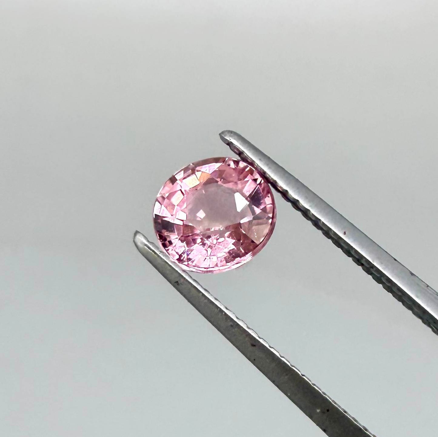 Natural untreated pink tourmaline, 0.57 ct round cut from Nigeria, eye-clean with bright pink colour and excellent brilliance.