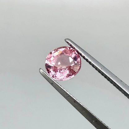 Natural untreated pink tourmaline, 0.57 ct round cut from Nigeria, eye-clean with bright pink colour and excellent brilliance.