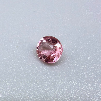 Natural untreated pink tourmaline, 0.57 ct round cut from Nigeria, eye-clean with bright pink colour and excellent brilliance.