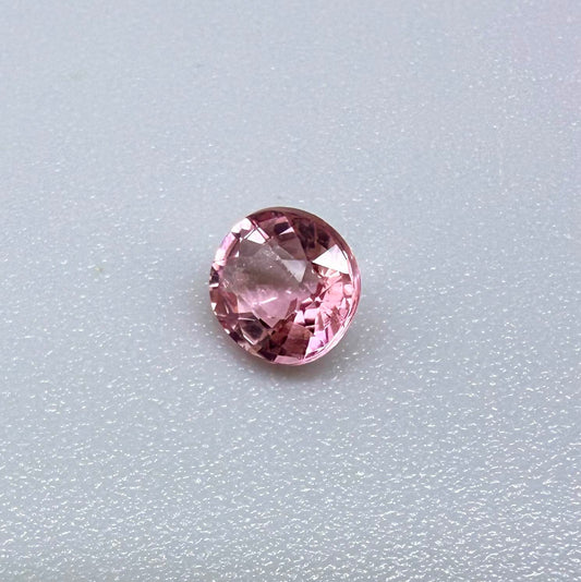 Natural untreated pink tourmaline, 0.57 ct round cut from Nigeria, eye-clean with bright pink colour and excellent brilliance.