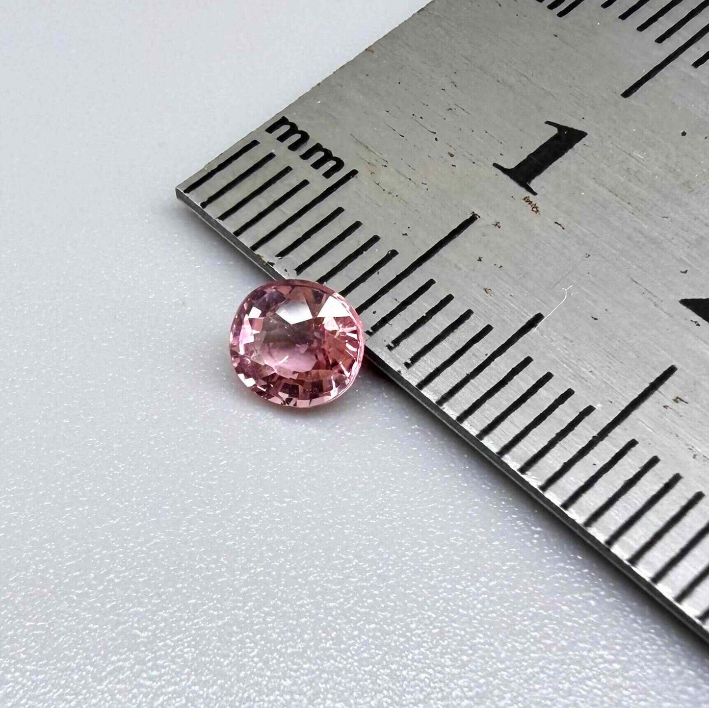 Natural untreated pink tourmaline, 0.57 ct round cut from Nigeria, eye-clean with bright pink colour and excellent brilliance.
