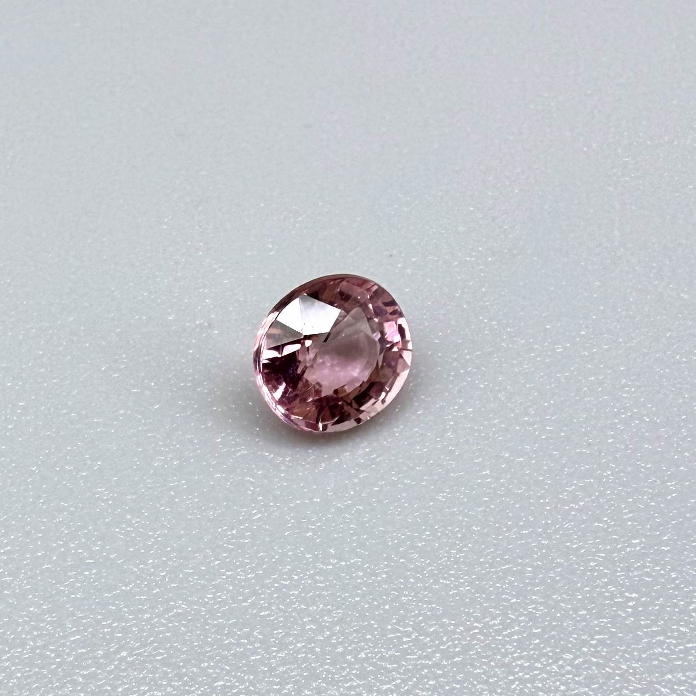 Natural untreated pink tourmaline, 0.57 ct round cut from Nigeria, eye-clean with bright pink colour and excellent brilliance.