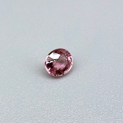 Natural untreated pink tourmaline, 0.57 ct round cut from Nigeria, eye-clean with bright pink colour and excellent brilliance.