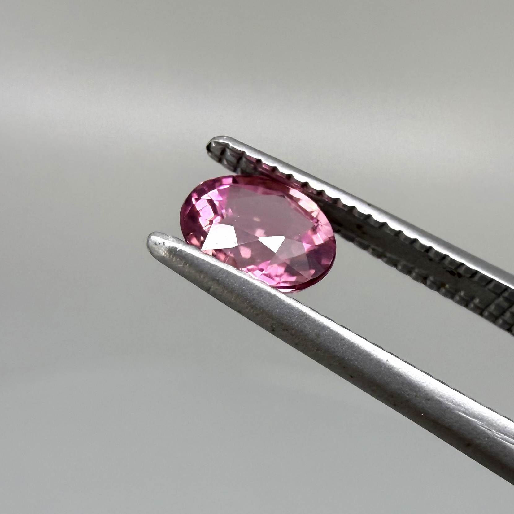 Natural untreated pink tourmaline, 0.56 ct oval cut from Nigeria with vivid pink colour, eye-clean clarity and excellent brilliance.