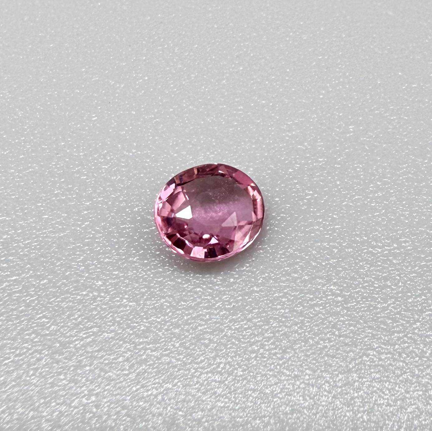 Natural untreated raspberry pink tourmaline, 0.41 ct round cut from Nigeria with vivid raspberry pink colour, eye-clean clarity and excellent brilliance.