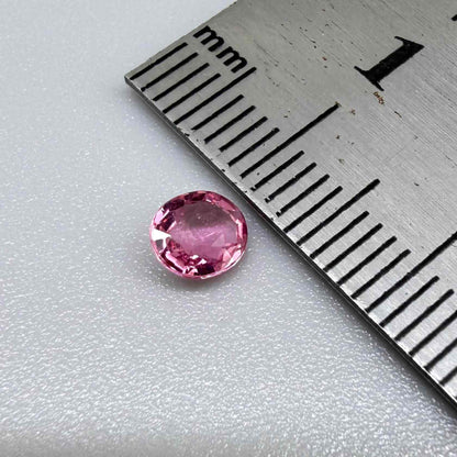 Natural untreated raspberry pink tourmaline, 0.41 ct round cut from Nigeria with vivid raspberry pink colour, eye-clean clarity and excellent brilliance.