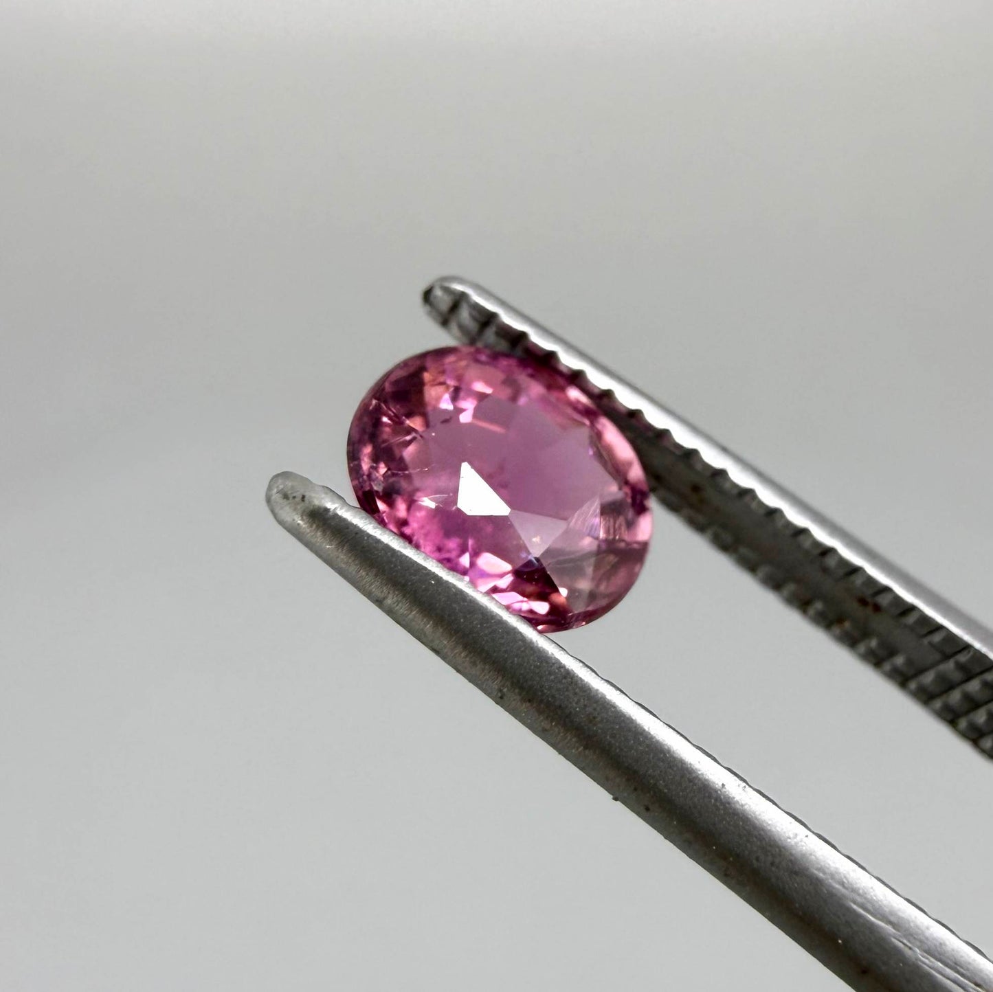 Natural untreated vivid magenta pink tourmaline, 0.66 ct oval cut from Nigeria with exceptional magenta pink colour, eye-clean clarity and outstanding brilliance.