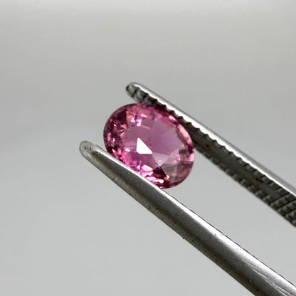 Natural untreated vivid magenta pink tourmaline, 0.66 ct oval cut from Nigeria with exceptional magenta pink colour, eye-clean clarity and outstanding brilliance.