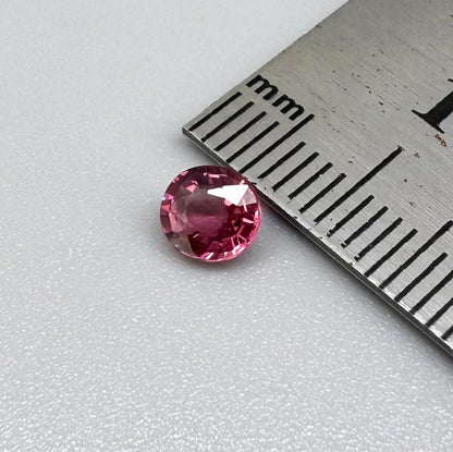 Natural untreated vivid raspberry pink tourmaline, 0.56 ct round cut from Nigeria with vivid raspberry pink colour, eye-clean clarity and exceptional brilliance.