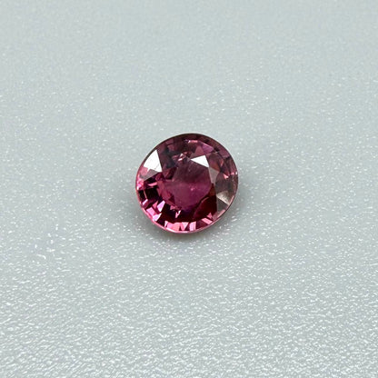 Natural untreated vivid raspberry pink tourmaline, 0.56 ct round cut from Nigeria with vivid raspberry pink colour, eye-clean clarity and exceptional brilliance.