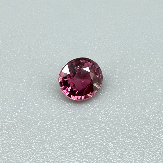 Natural untreated vivid raspberry pink tourmaline, 0.56 ct round cut from Nigeria with vivid raspberry pink colour, eye-clean clarity and exceptional brilliance.