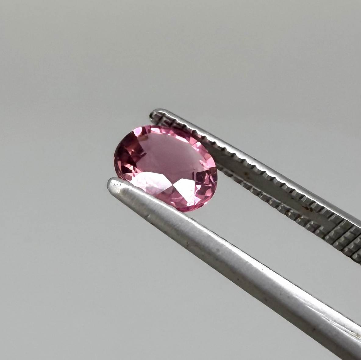 Natural untreated vivid raspberry pink tourmaline, 0.56 ct round cut from Nigeria with vivid raspberry pink colour, eye-clean clarity and exceptional brilliance.