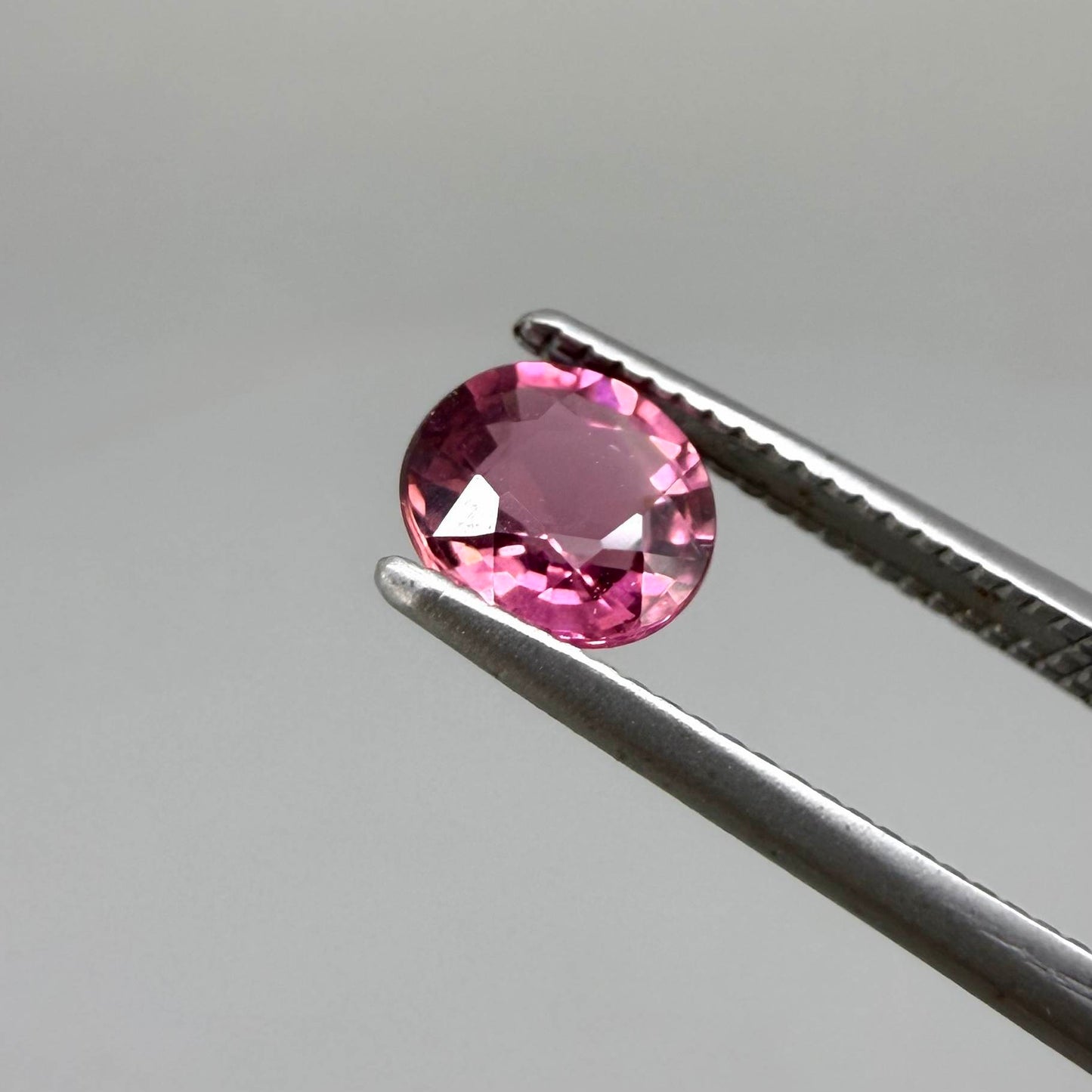 Natural untreated vivid raspberry pink tourmaline, 0.56 ct round cut from Nigeria with vivid raspberry pink colour, eye-clean clarity and exceptional brilliance.