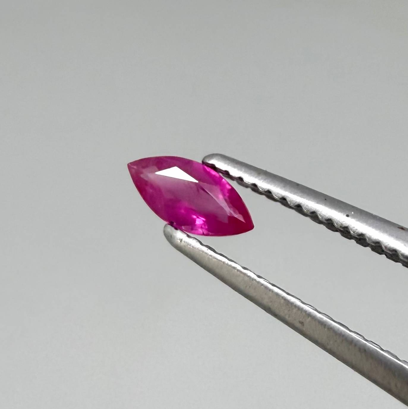 Faceted marquise-cut pinkish-red ruby pair with a total weight of 0.34 ct, eye-clean appearance with natural inclusions
