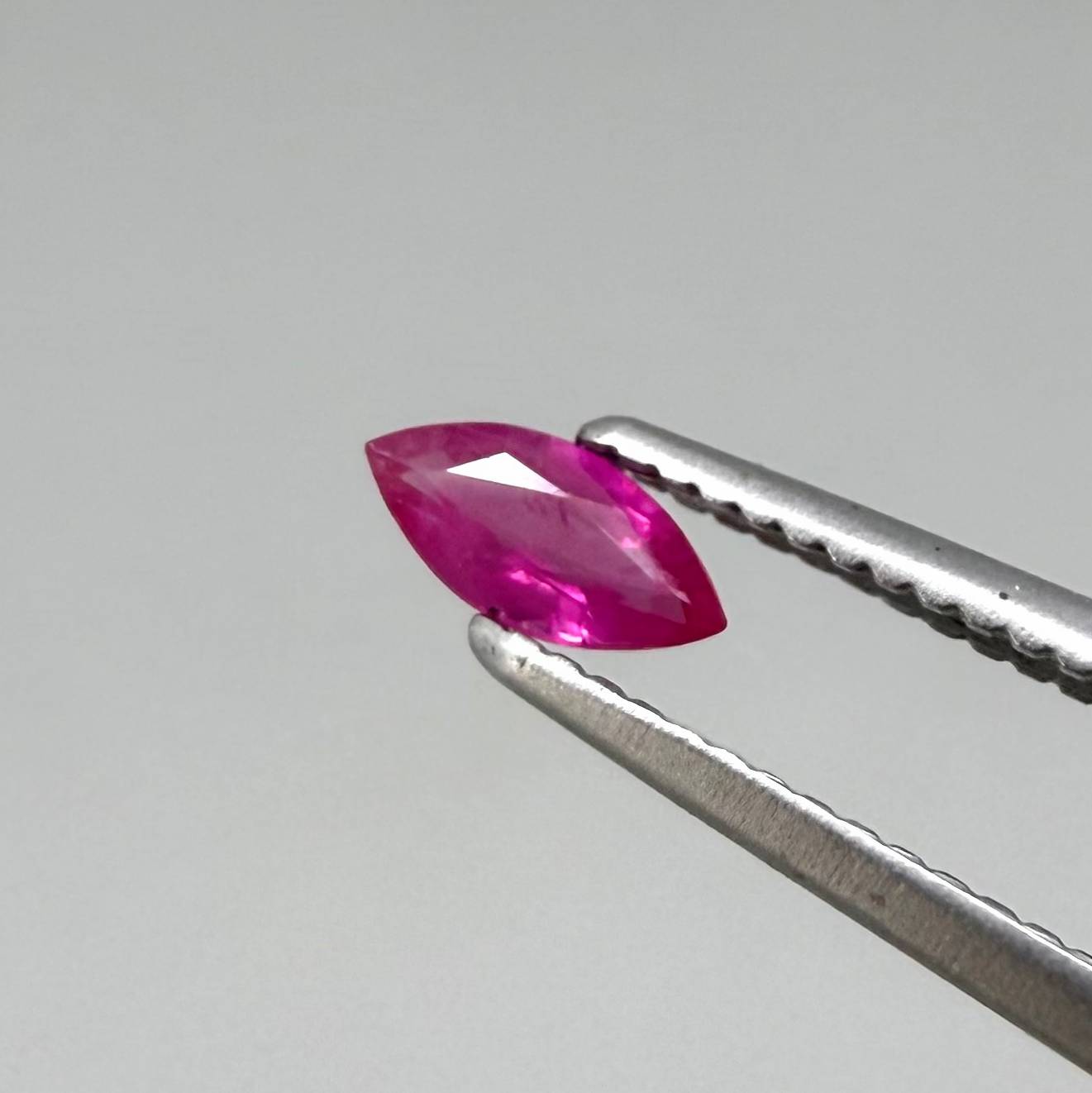 Faceted marquise-cut pinkish-red ruby pair with a total weight of 0.34 ct, eye-clean appearance with natural inclusions