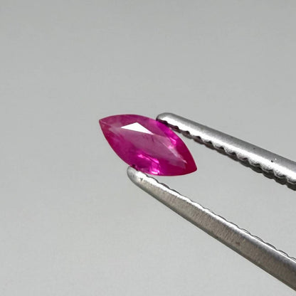Faceted marquise-cut pinkish-red ruby pair with a total weight of 0.34 ct, eye-clean appearance with natural inclusions
