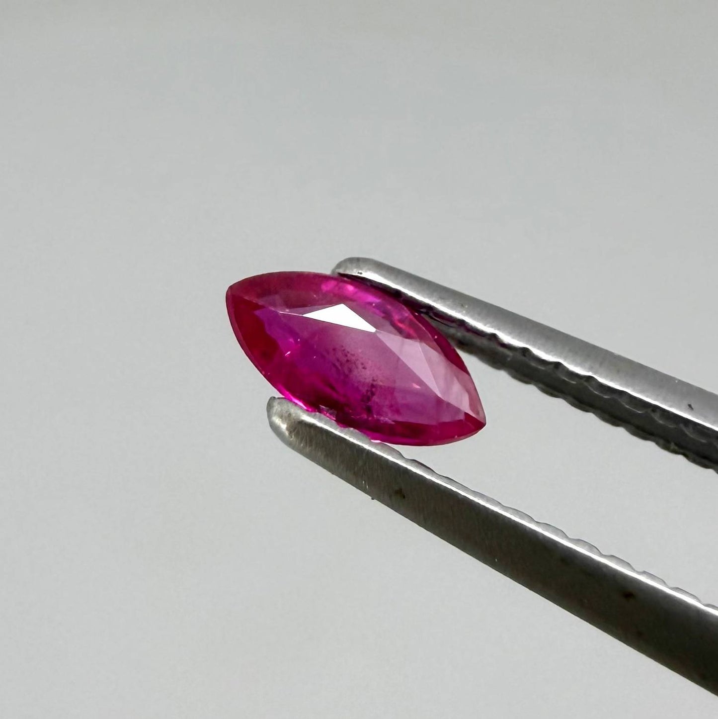 Faceted marquise-cut pinkish-red ruby pair with a total weight of 0.34 ct, eye-clean appearance with natural inclusions