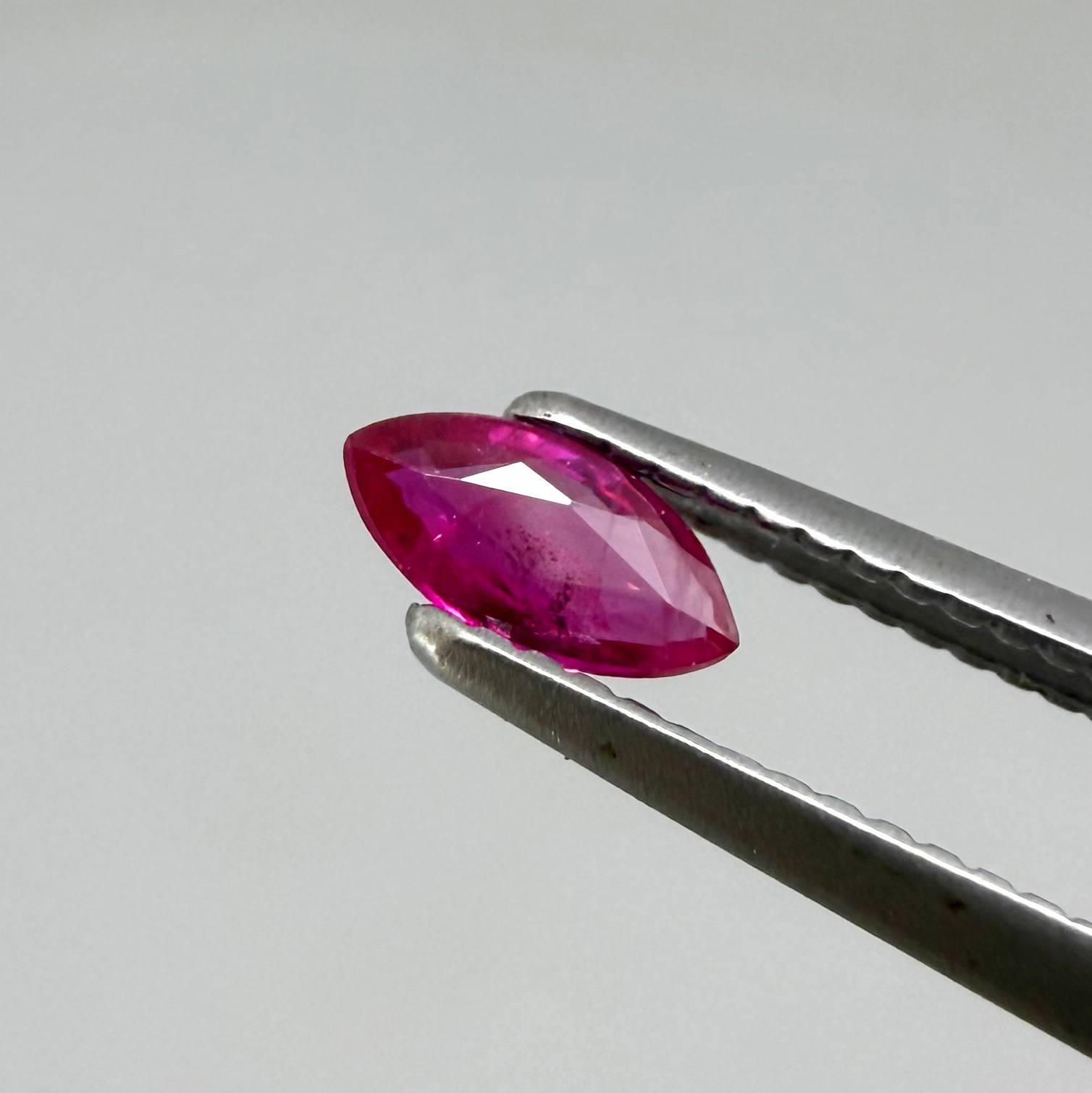 Faceted marquise-cut pinkish-red ruby pair with a total weight of 0.34 ct, eye-clean appearance with natural inclusions