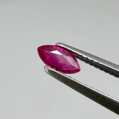 Faceted marquise-cut pinkish-red ruby pair with a total weight of 0.34 ct, eye-clean appearance with natural inclusions
