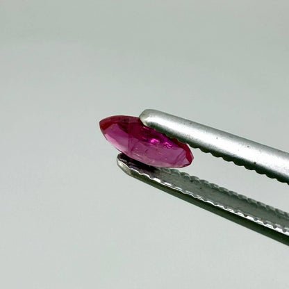 Faceted marquise-cut pinkish-red ruby pair with a total weight of 0.34 ct, eye-clean appearance with natural inclusions