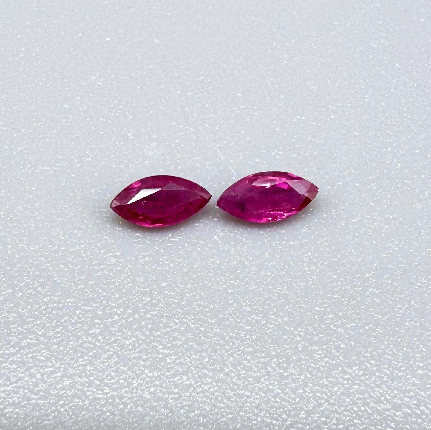 Two reddish-pink marquise-cut rubies, with a total of 0.33 ct, eye-clean appearance with fine natural inclusions